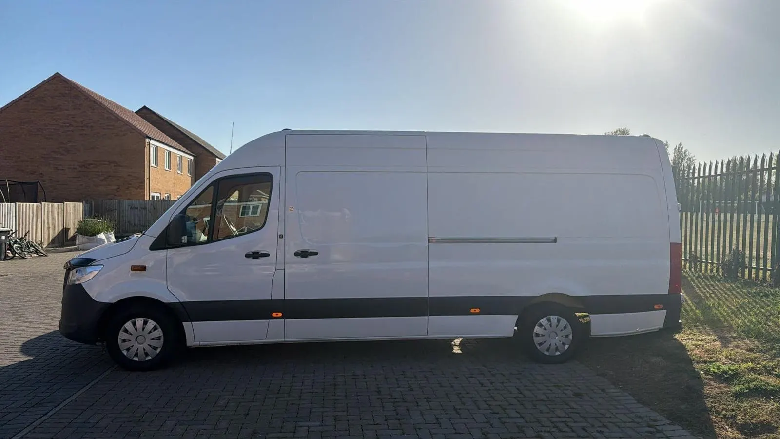 White Mercedes Sprinter long-wheelbase van seen from the side